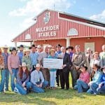 StoryCheckPass2010 for web Therral and Jan Story, center, present a check for $2 million to Dr. David Rankin, the SAU rodeo team, and other administrators.