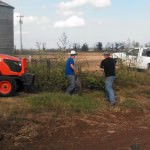 Southern Arkansas University students work to clear brush in preparation for the first crops at the Monroe farm in southern Lafayette County. The farm property recently became available for use by SAU through a trust agreement.
