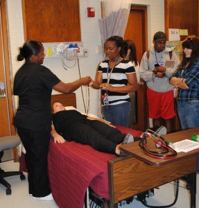 Senior BSN Student Karla Fuller educates pre-nursing students in a simulation lab experience on vital signs during their past visit to Wharton Nursing Building.